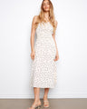 White dress with black polka dots, featuring a v-neckline and wide straps for a chic look by Charlie B.