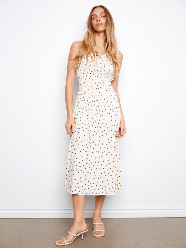 White dress with black polka dots, featuring a v-neckline and wide straps for a chic look by Charlie B.