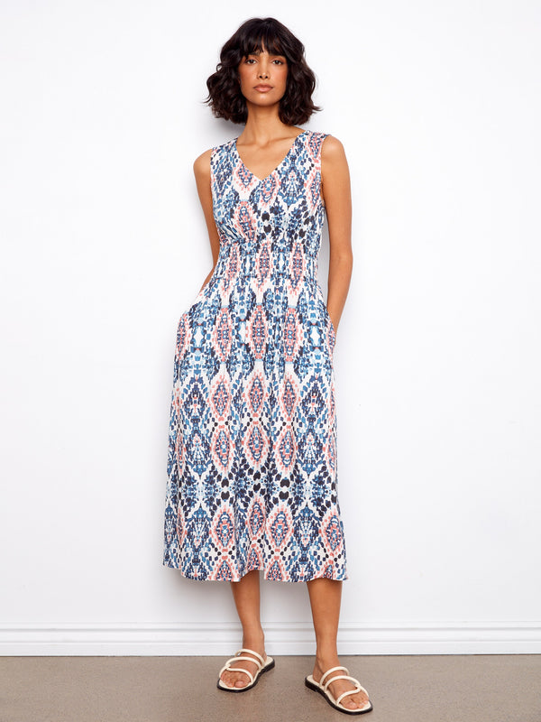 This dress features a V-neck design and wide straps, offering a stylish yet comfortable fit for any occasion. By Charlie B.