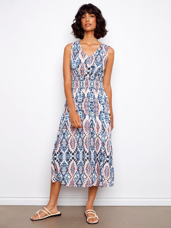 The smocked waist adds a flattering touch to this midi-length dress, perfect for both casual and formal settings. By Charlie B.