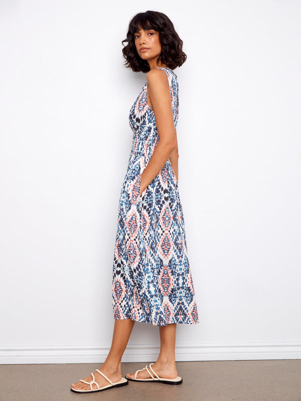 With hidden pockets, this dress combines practicality with elegance in its intricate pattern. By Charlie B.