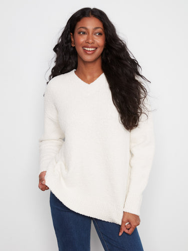 Ecru boucle sweater with relaxed fit and V-neck, perfect for cozy days. Long sleeves add warmth by Charlie B.