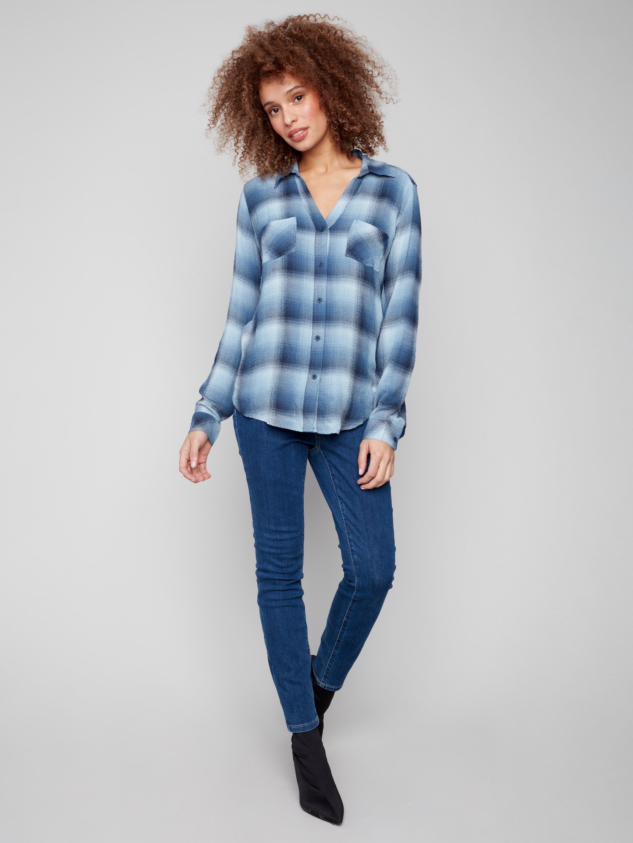 Plaid blouse in shades of blue with long sleeves, perfect for versatile styling options by Charlie B.