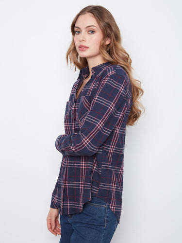 This plaid blouse features a rounded hemline, adding a touch of elegance to the casual design by Charlie B.