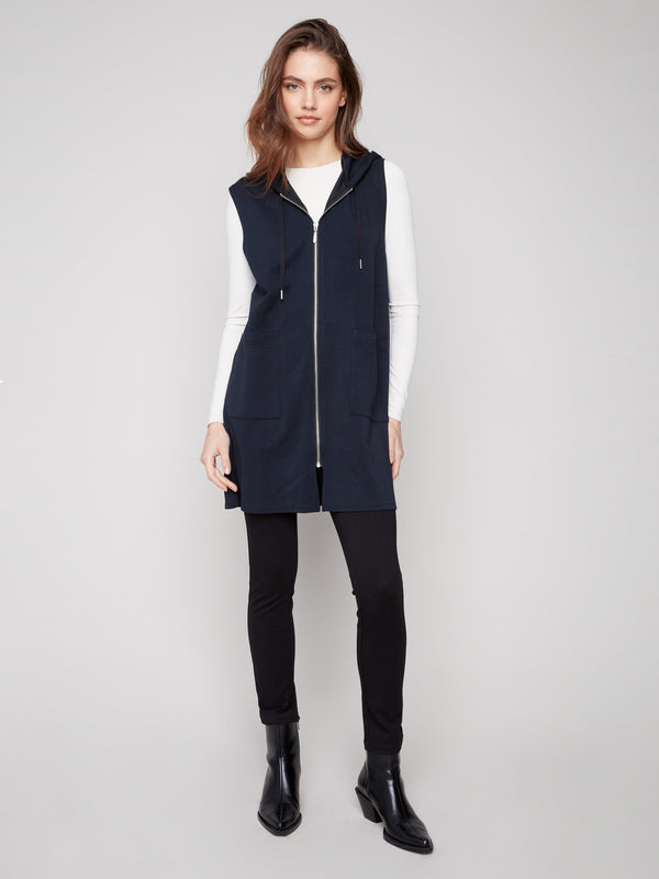 Black sleeveless vest with mid-thigh length, featuring a zip front and patch pockets by Charlie B.