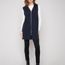 Black sleeveless vest with mid-thigh length, featuring a zip front and patch pockets by Charlie B.