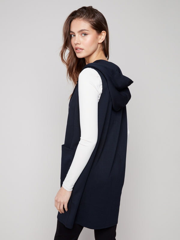 Chic black vest showcasing a zip front closure and attached hood for versatile styling by Charlie B.
