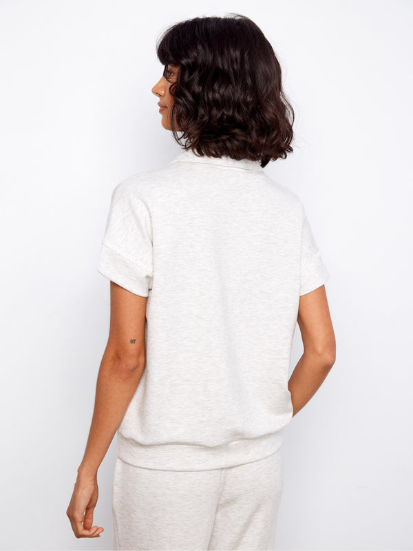 Chic short sleeve top in heather light grey, showcasing a refined design with blanket stitch accents for style by Charlie B.
