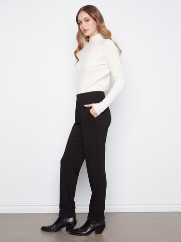 The pants come equipped with practical slash pockets, blending functionality and fashion seamlessly. A creation by Charlie B.