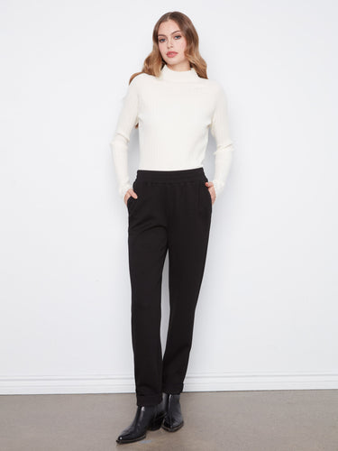 Crafted from premium materials, these black tapered-fit trousers offer unmatched comfort and style for any occasion. By Charlie B.