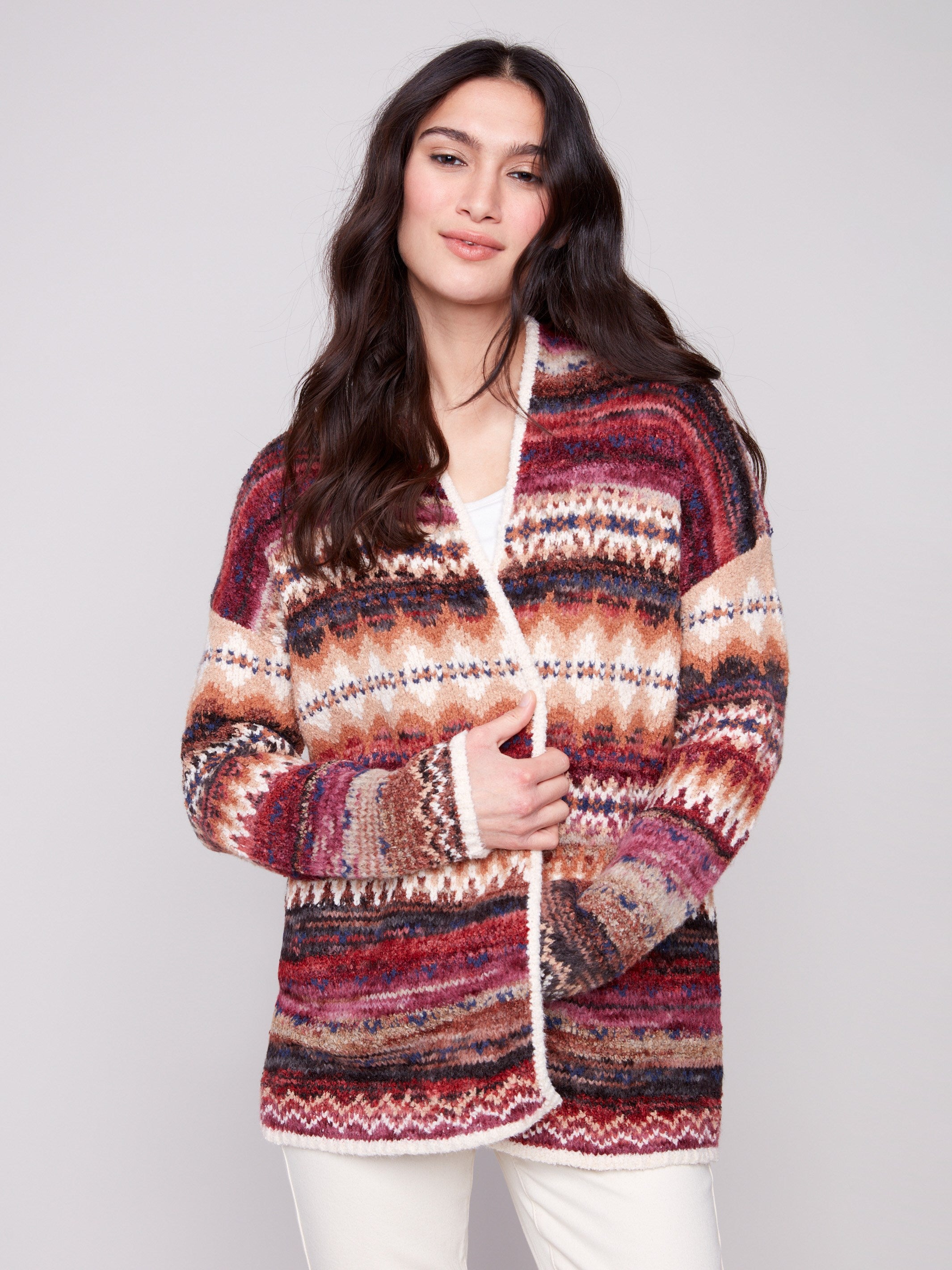 This cardigan showcases an open front design with vibrant jewel tones and geometric patterns by Charlie B.