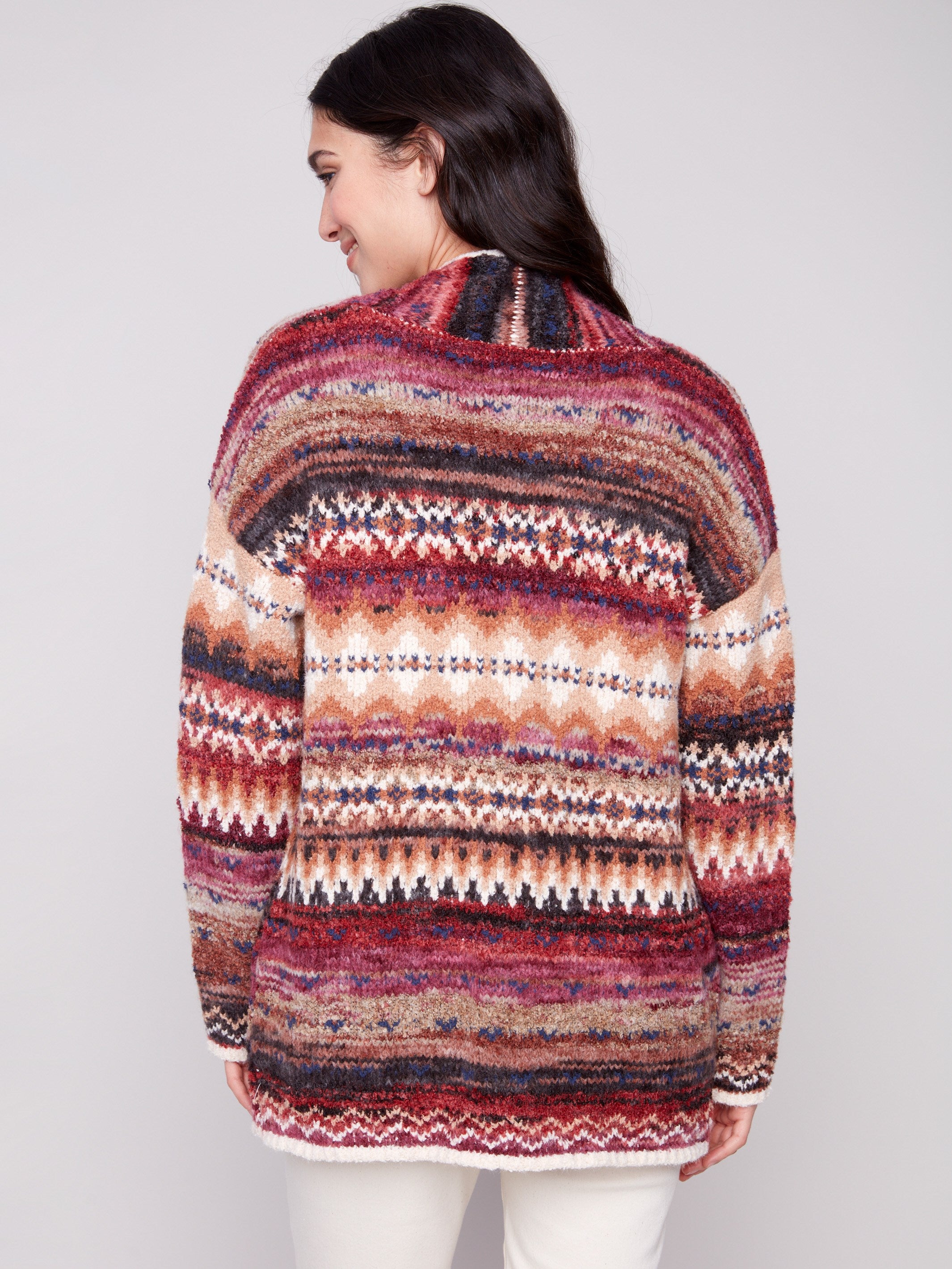 The cardigan's drop shoulder design enhances its relaxed fit, paired with a striking geometric pattern by Charlie B.