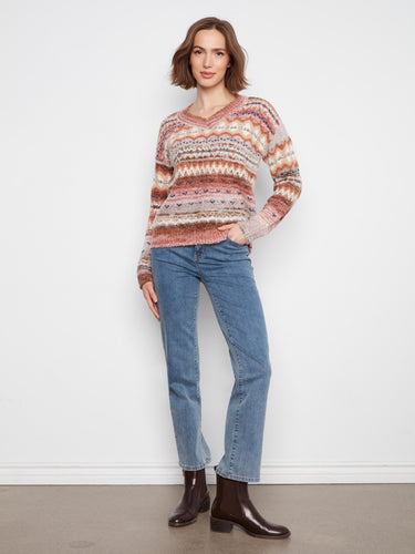 Space dye sweater with long sleeves and ribbed cuffs, offering comfort in earthy tones. By Charlie B.