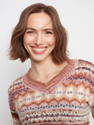 Earthy-hued space dye sweater showcasing elegant drop shoulders and ribbed details. By Charlie B.