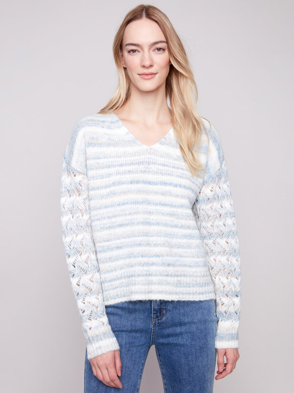 Women's sweater featuring a V-neck design in a space dye pattern with drop shoulders for effortless style by Charlie B.