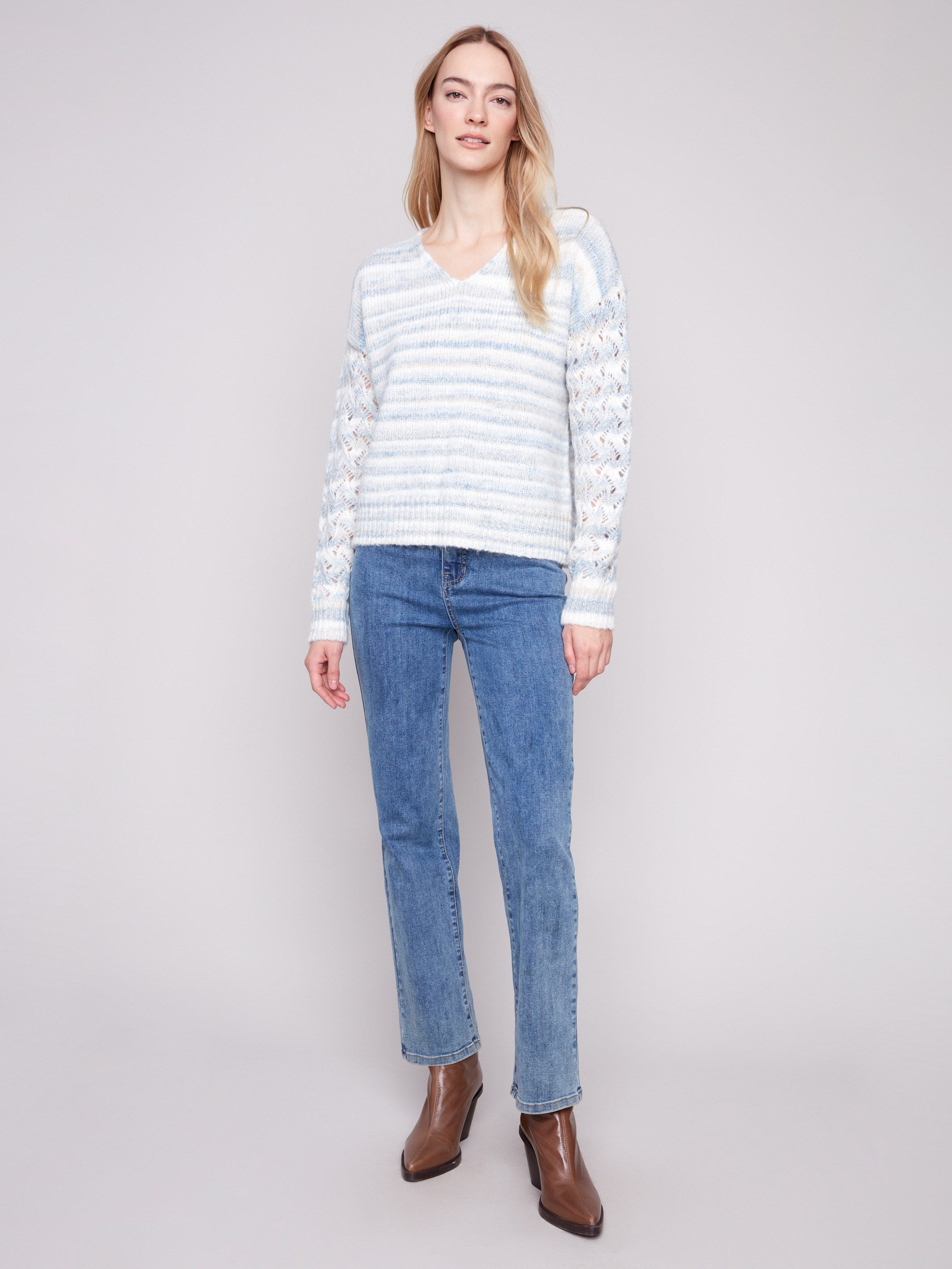 Stylish women's sweater with open knit sleeves and a striped pattern, showcasing drop shoulder detailing by Charlie B.