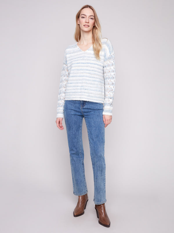 Stylish women's sweater with open knit sleeves and a striped pattern, showcasing drop shoulder detailing by Charlie B.