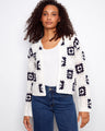 White crochet cardigan with crew neck and geometric patterns, perfect for layering by Charlie B.