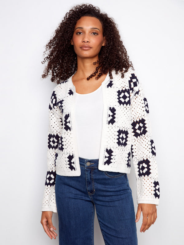 White crochet cardigan with crew neck and geometric patterns, perfect for layering by Charlie B.