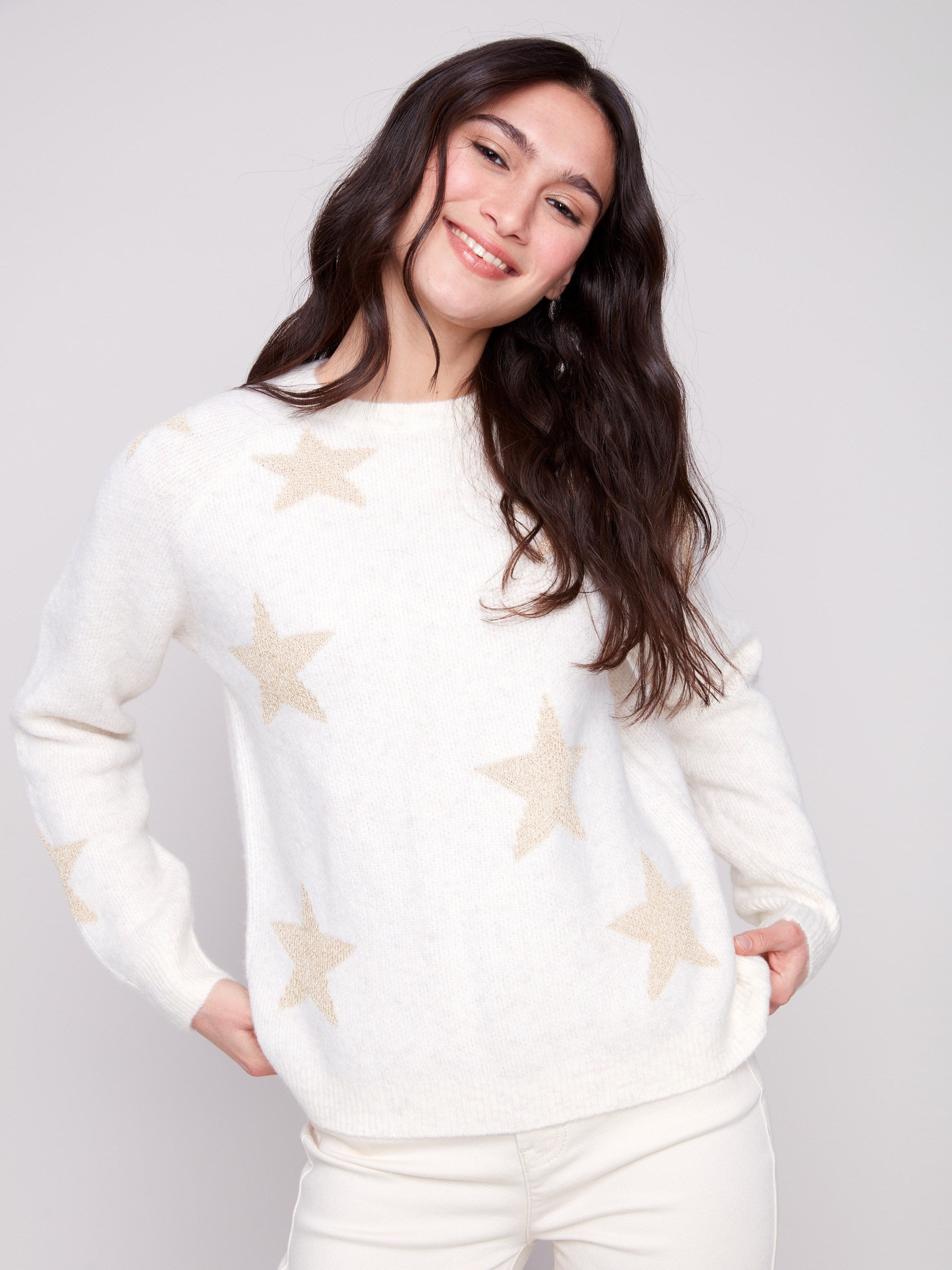 White sweater adorned with subtle metallic stars, offering a cozy plush knit texture for added comfort by Charlie B.
