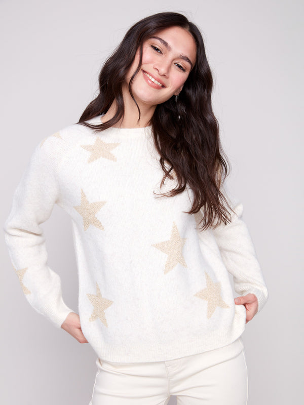White sweater adorned with subtle metallic stars, offering a cozy plush knit texture for added comfort by Charlie B.