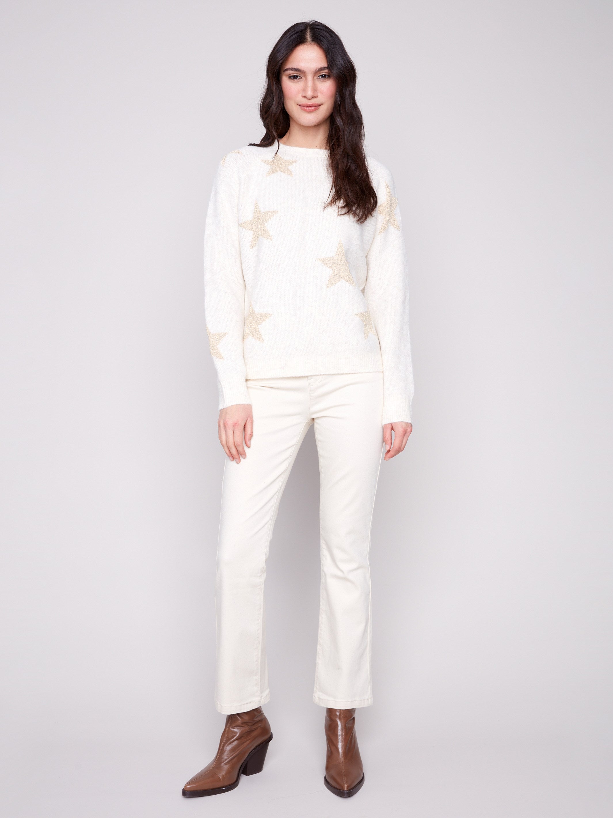 Elegant white sweater showcasing raglan sleeves and shimmering stars, perfect for a stylish look by Charlie B.