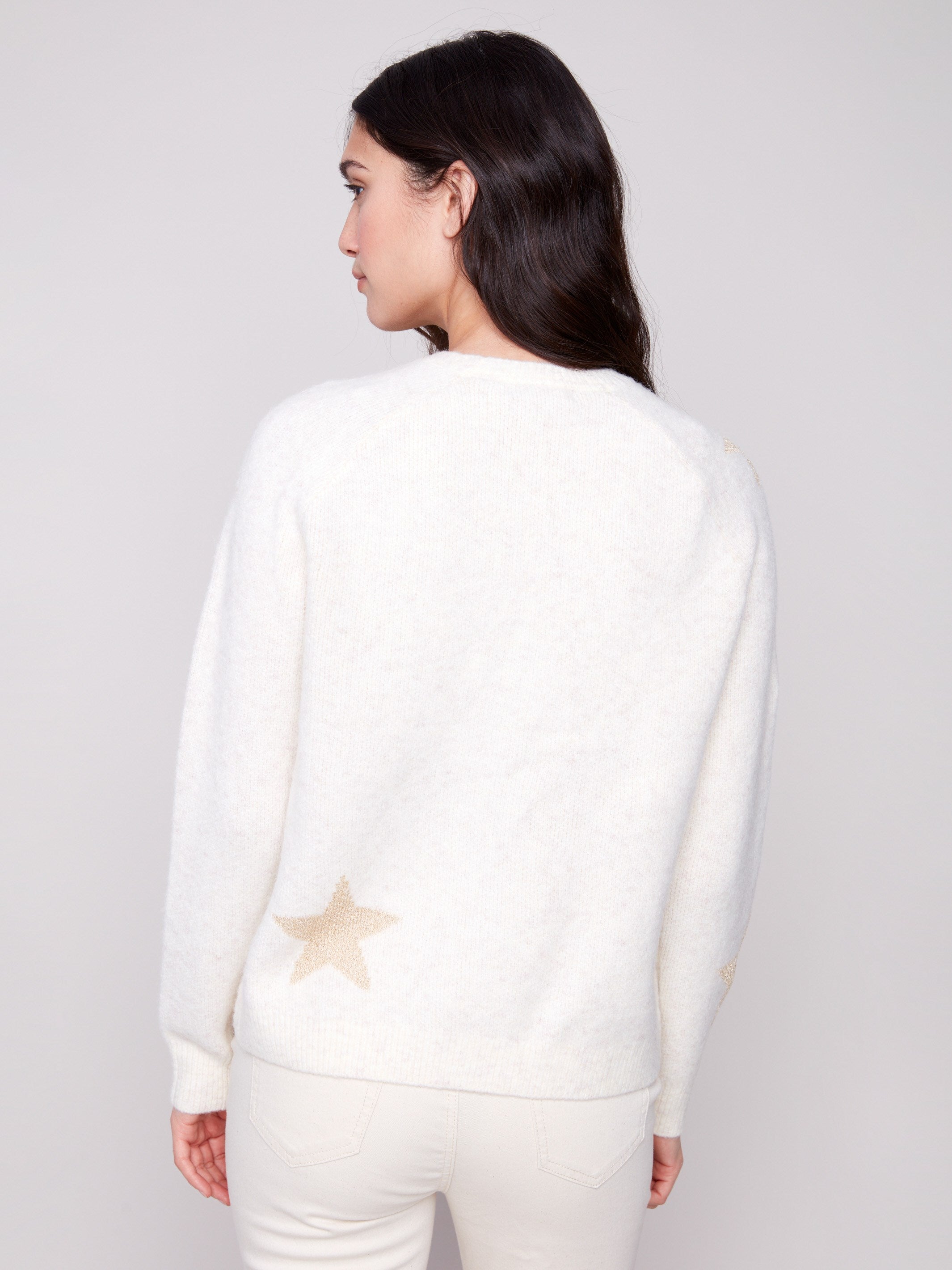 Chic white sweater with plush knit fabric and shimmering star details, providing warmth and style by Charlie B.