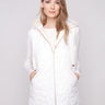 Ecru vest with quilted stars, featuring a hood with drawstrings and practical welt pockets for added style by Charlie B.