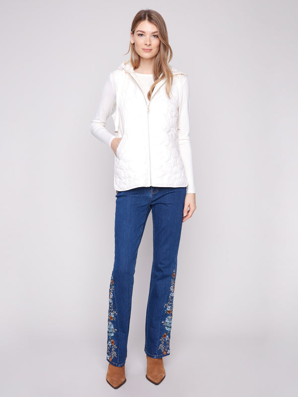 This short vest showcases a zipper front closure, complete with star quilting and an attached hood for versatility by Charlie B.