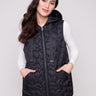 Black vest with hood and drawstrings, featuring quilted stars and welt pockets, perfect for layering by Charlie B.