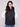 Chic black vest showcasing quilted stars and convenient welt pockets, complete with a hood by Charlie B.