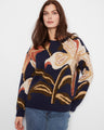 Navy blue sweater with abstract floral design, featuring a relaxed fit and ribbed cuffs for comfort by Charlie B.
