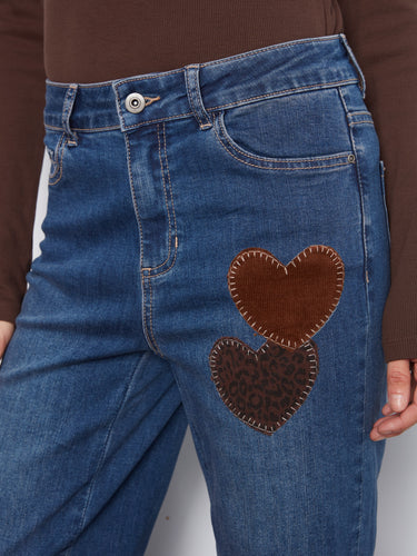 Stylish stretch denim jeans with leopard-print heart patches, adding a playful touch to your wardrobe. By Charlie B.