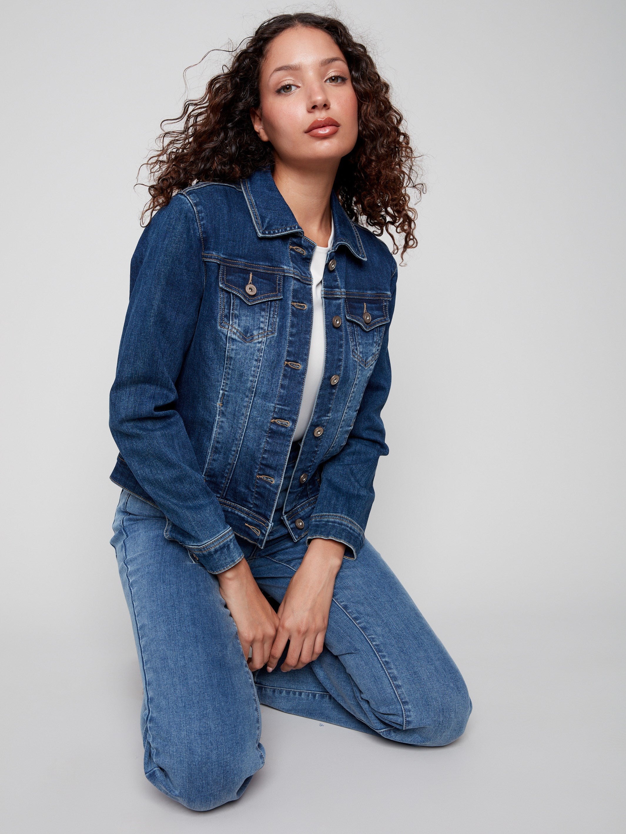 This indigo denim jacket offers a trendy button front, ideal for layering in any season by Charlie B.