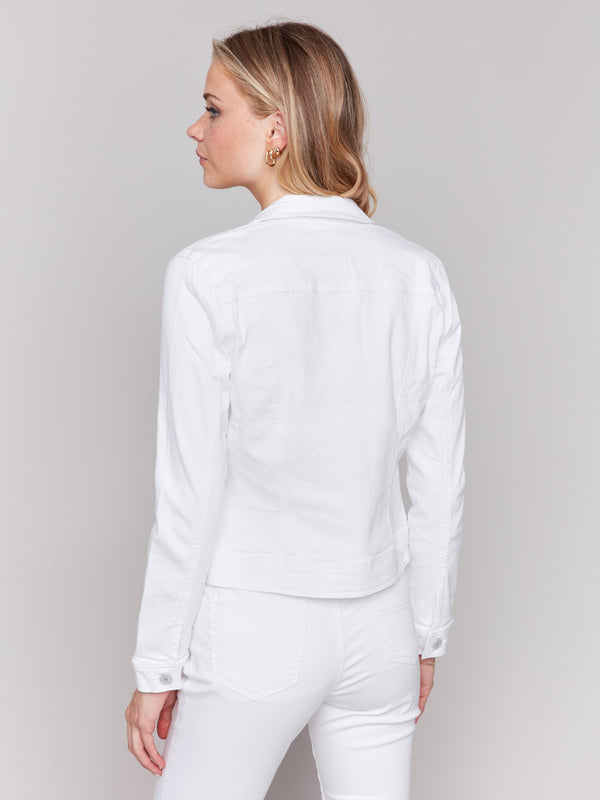 White stretch denim jacket with long sleeves and faux front pockets, featuring a button-up front by Charlie B.