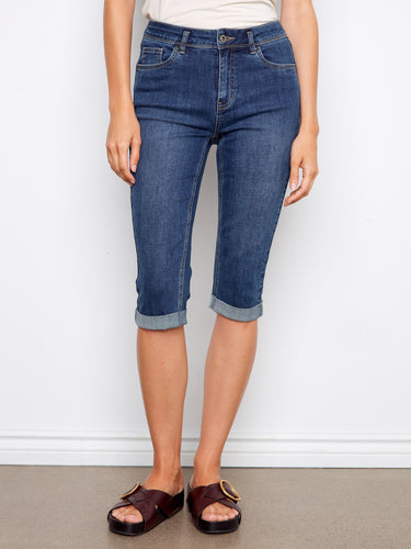 Model wearing indigo capri length pedal pushers with a flattering slim fit design by Charlie B.