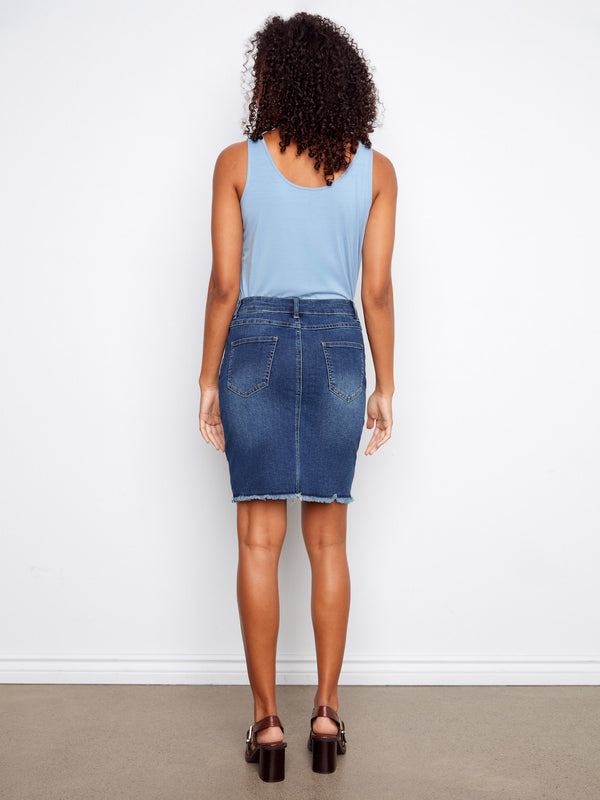 Classic design meets modern flair in this regular rise denim skirt with unique frayed edges. By Charlie B.