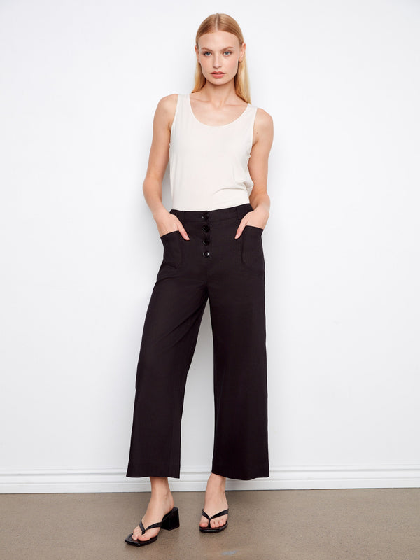 Black pants with a wide leg fit and cropped length, showcasing patch pockets. Designed for style and comfort by Charlie B.