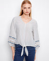 Elegant striped blouse with intricate embroidery on sleeves, crafted from 100% cotton by Charlie B.