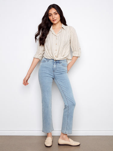 This button-front closure striped shirt pairs well with jeans, offering a stylish yet relaxed look for everyday wear by Charlie B.
