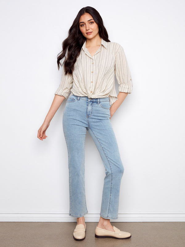 This button-front closure striped shirt pairs well with jeans, offering a stylish yet relaxed look for everyday wear by Charlie B.