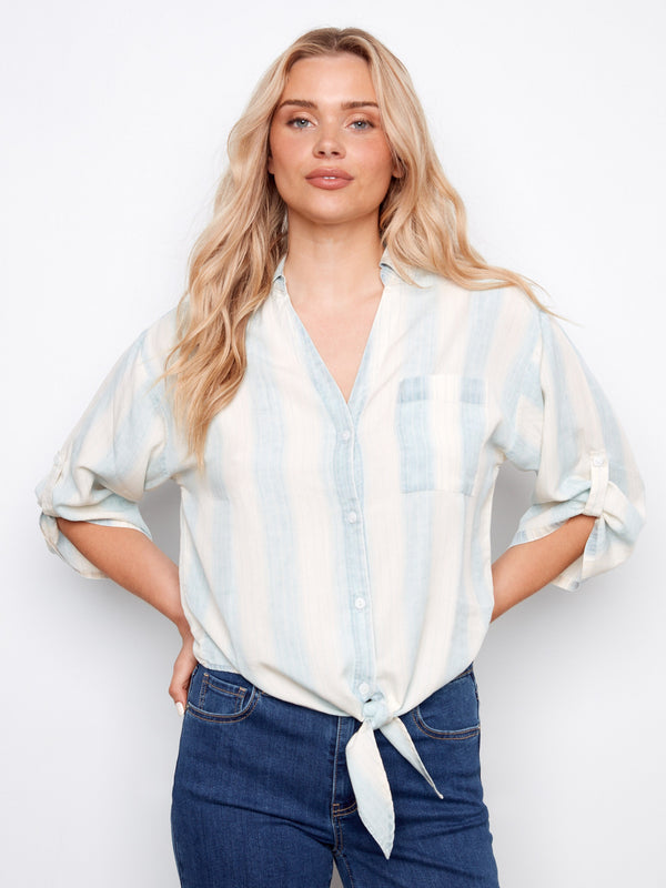 Light blue striped shirt featuring a collared V-neckline and button-down front, perfect for casual outings. By Charlie B.