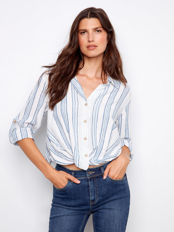 The shirt features a classic shirt collar, enhancing its timeless appeal. The striped pattern adds a touch of elegance. By Charlie B.