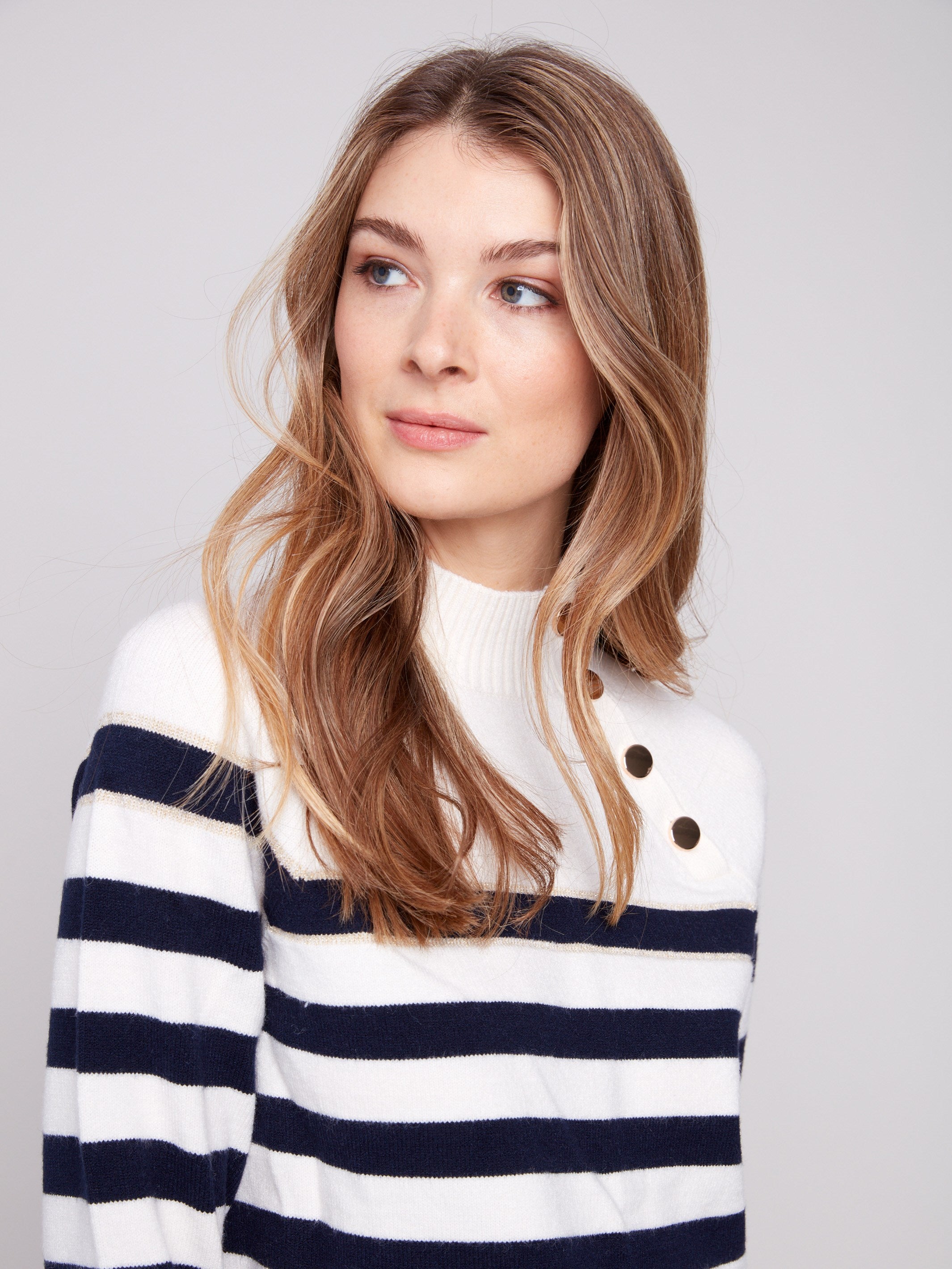 Elegant offwhite striped sweater showcasing subtle gold detail for a touch of sophistication by Charlie B.