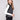 Black sweater vest featuring a crew neck with white stripes, adding a modern touch to any outfit by Charlie B.