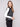 Black sweater vest featuring a crew neck with white stripes, adding a modern touch to any outfit by Charlie B.