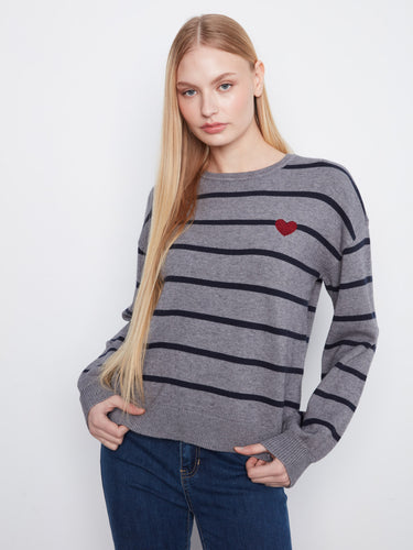Striped sweater with a classic crew neck design, featuring ribbed cuffs and hem for added comfort. By Charlie B.