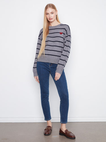 Stylish sweater showcasing heart embroidery on the chest, adding a touch of charm to the striped pattern. By Charlie B.
