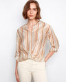 The blouse features a split notch neckline, enhancing its stylish appeal with a touch of elegance. By Charlie B.