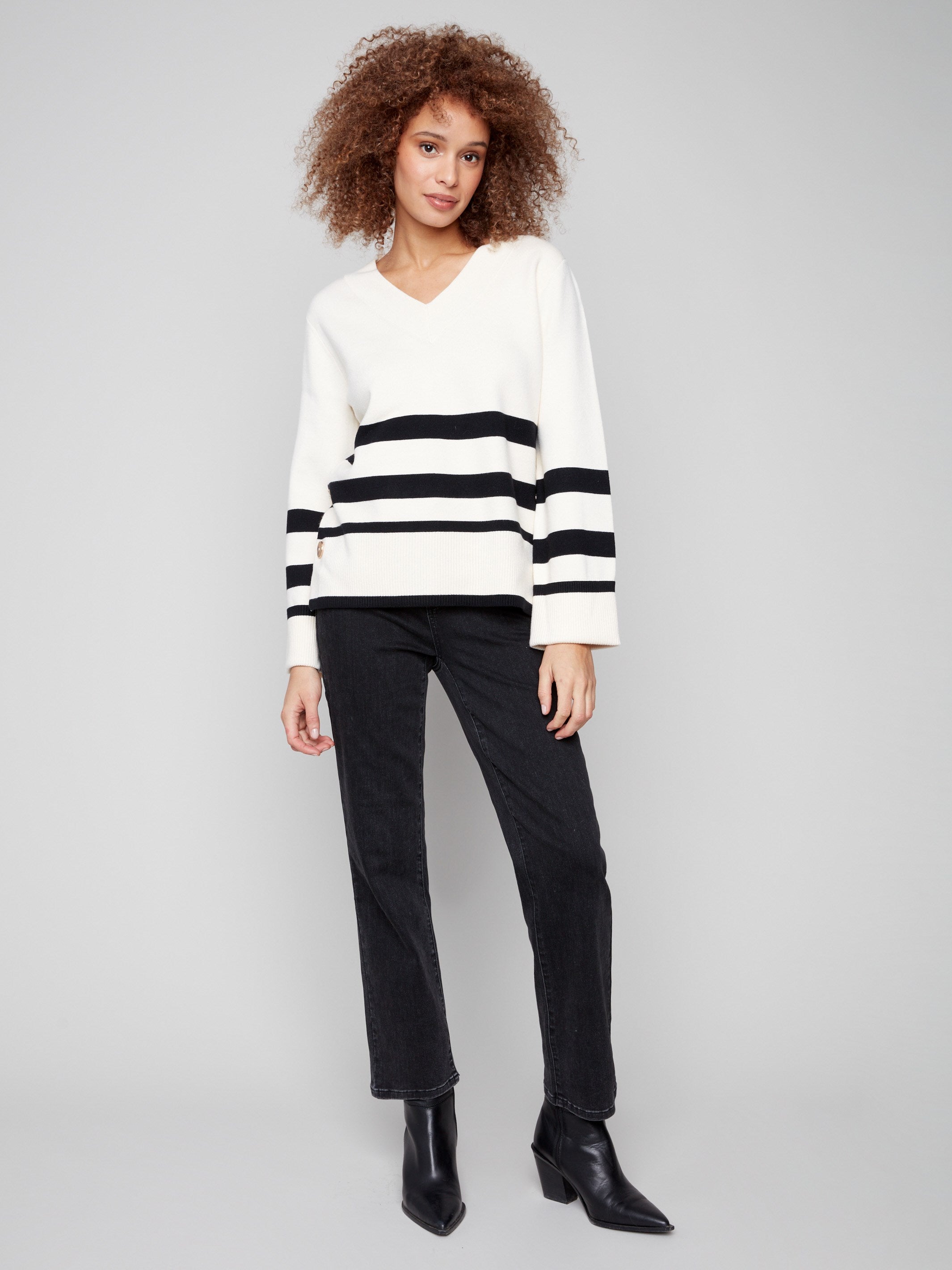 Chic ecru sweater featuring buttons at sleeves and sides, paired with a flattering V-neck by Charlie B.